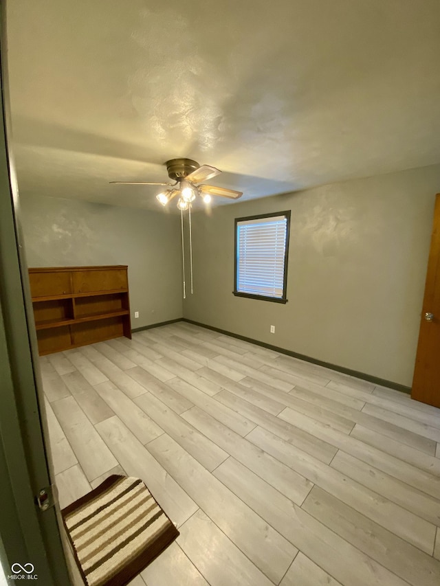 interior space with ceiling fan