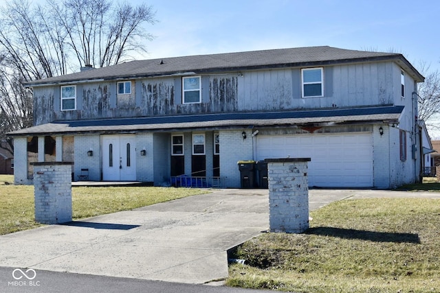 view of property with a front lawn and a garage