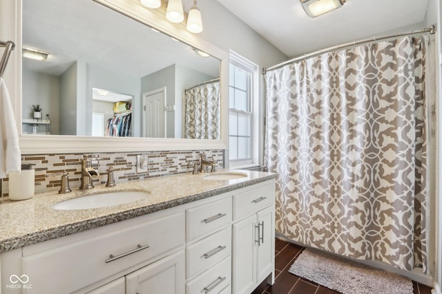 bathroom with tasteful backsplash and vanity