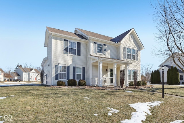 view of front of home with a porch and a front yard