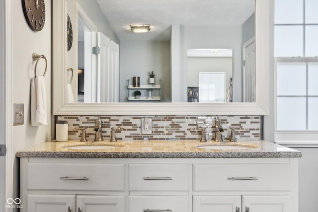 bathroom with tasteful backsplash and vanity