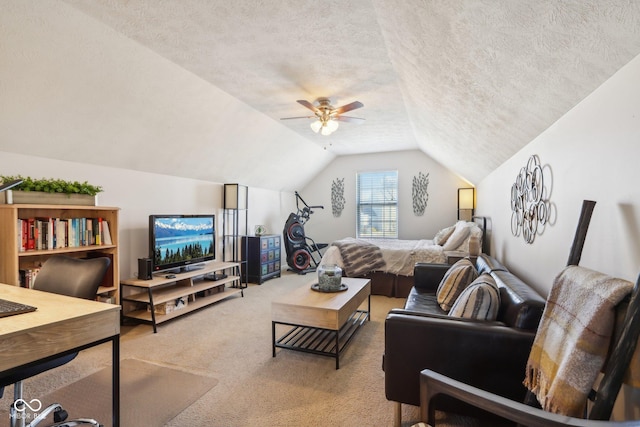 bedroom featuring ceiling fan, vaulted ceiling, a textured ceiling, and carpet