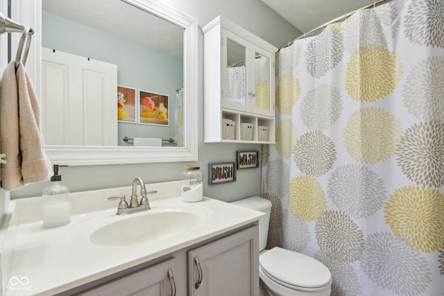 bathroom featuring vanity and toilet