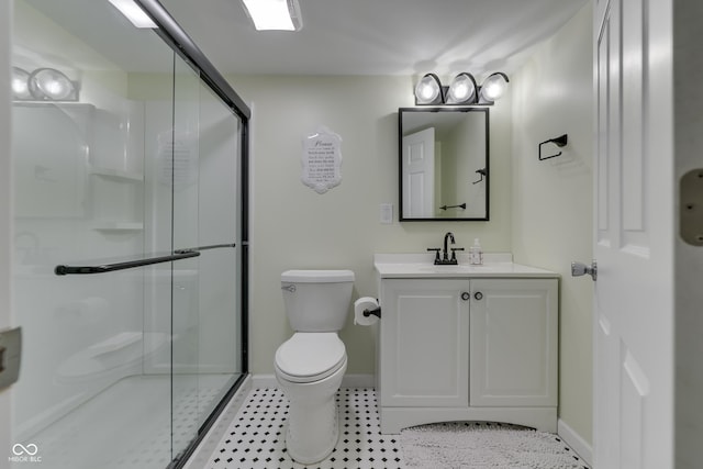 bathroom with toilet, walk in shower, and vanity