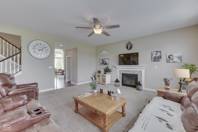 carpeted living room featuring ceiling fan