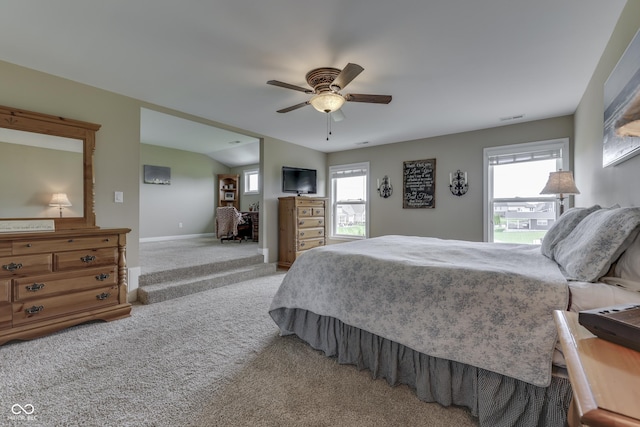 carpeted bedroom featuring ceiling fan and multiple windows