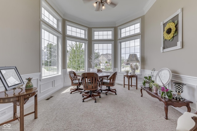 carpeted dining area featuring ceiling fan and ornamental molding