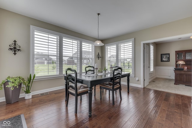 dining space with dark hardwood / wood-style flooring