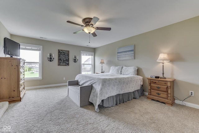 bedroom with ceiling fan and light carpet