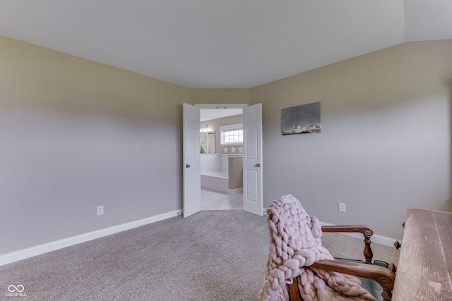 office space featuring light carpet and vaulted ceiling