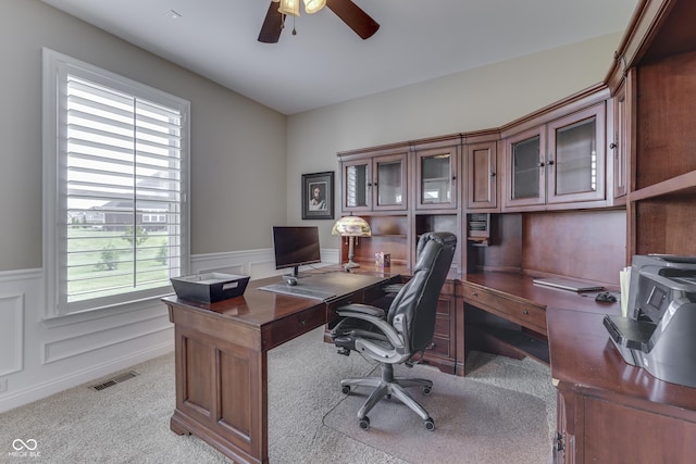 carpeted office featuring ceiling fan