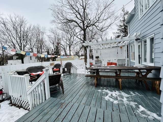 snow covered deck featuring a pergola