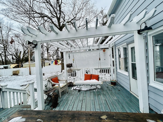 snow covered deck featuring a pergola