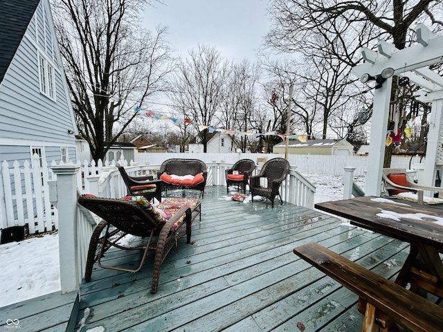 snow covered deck featuring outdoor lounge area