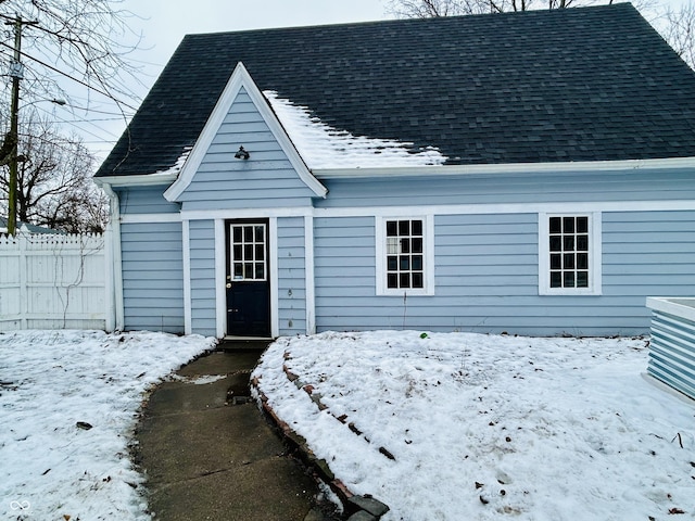 view of snow covered rear of property