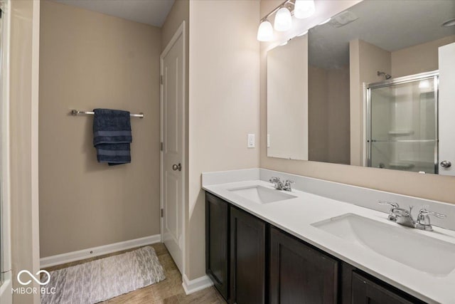 bathroom featuring vanity and a shower with shower door