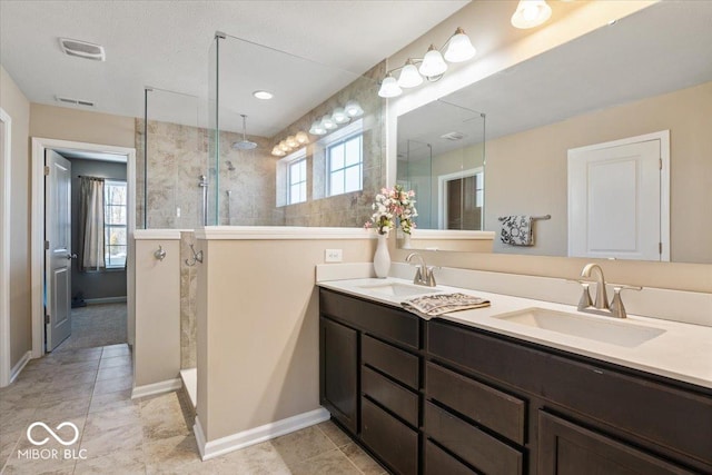 bathroom with vanity and tiled shower