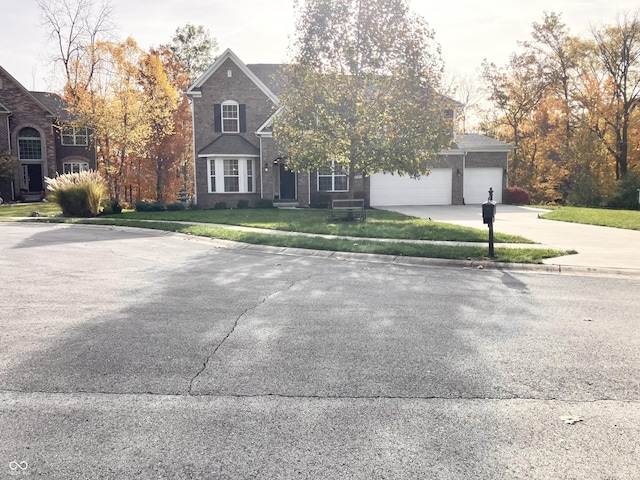 view of front of house with a garage and a front lawn