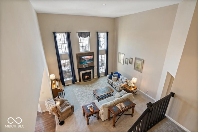 living room with plenty of natural light, hardwood / wood-style floors, and a high ceiling