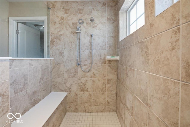 bathroom with a tile shower