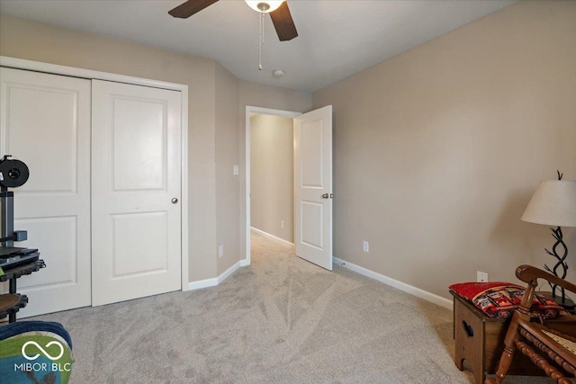 interior space with light carpet and ceiling fan