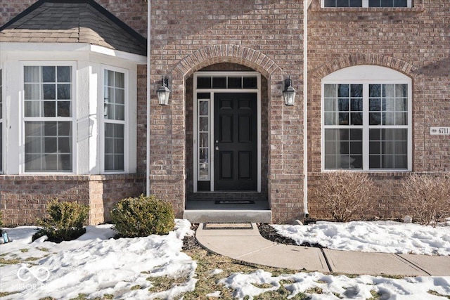 view of snow covered property entrance