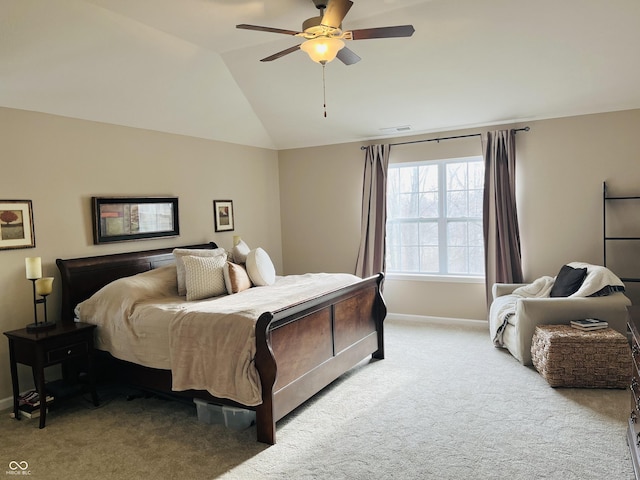 bedroom with ceiling fan, vaulted ceiling, and light carpet