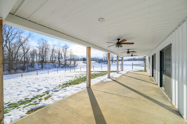 snow covered patio featuring ceiling fan