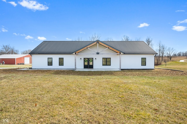 view of front of home featuring metal roof and a front lawn