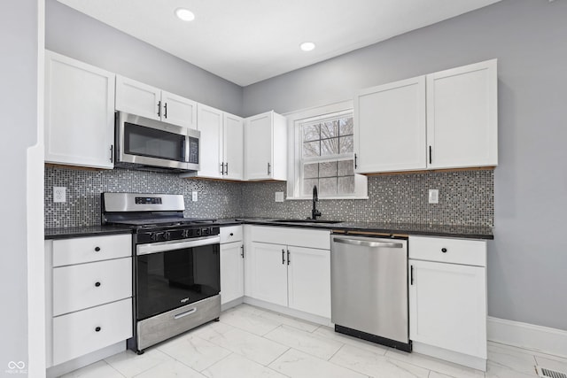 kitchen with sink, white cabinetry, and stainless steel appliances