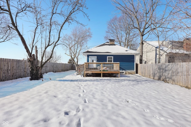 snow covered property with a deck