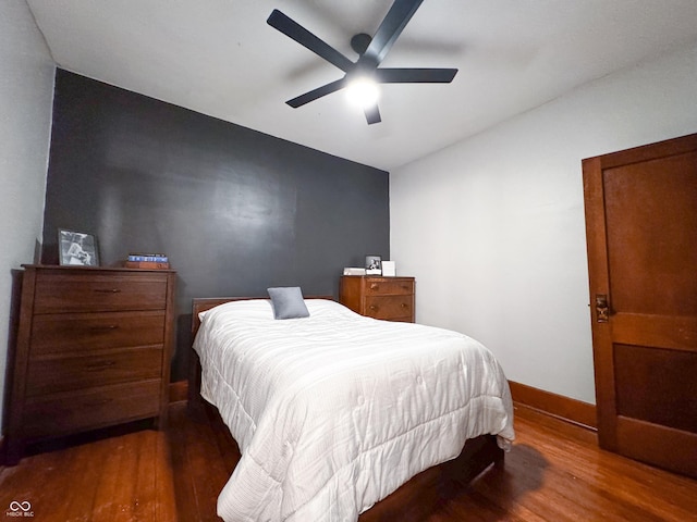 bedroom featuring ceiling fan and dark wood-type flooring