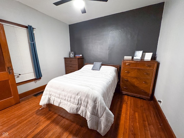 bedroom with ceiling fan and dark hardwood / wood-style floors