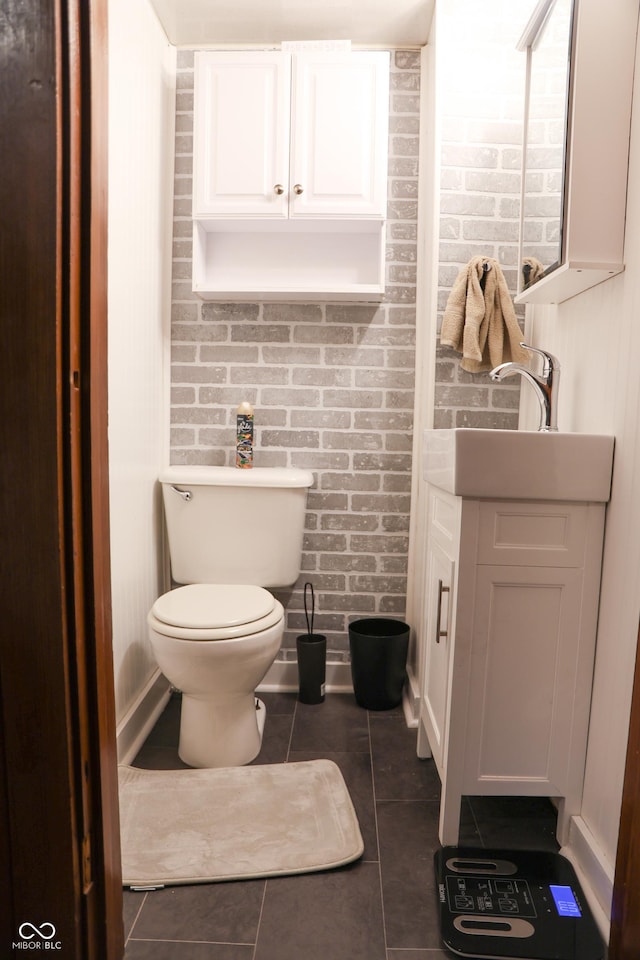 bathroom with toilet, tile patterned flooring, and vanity