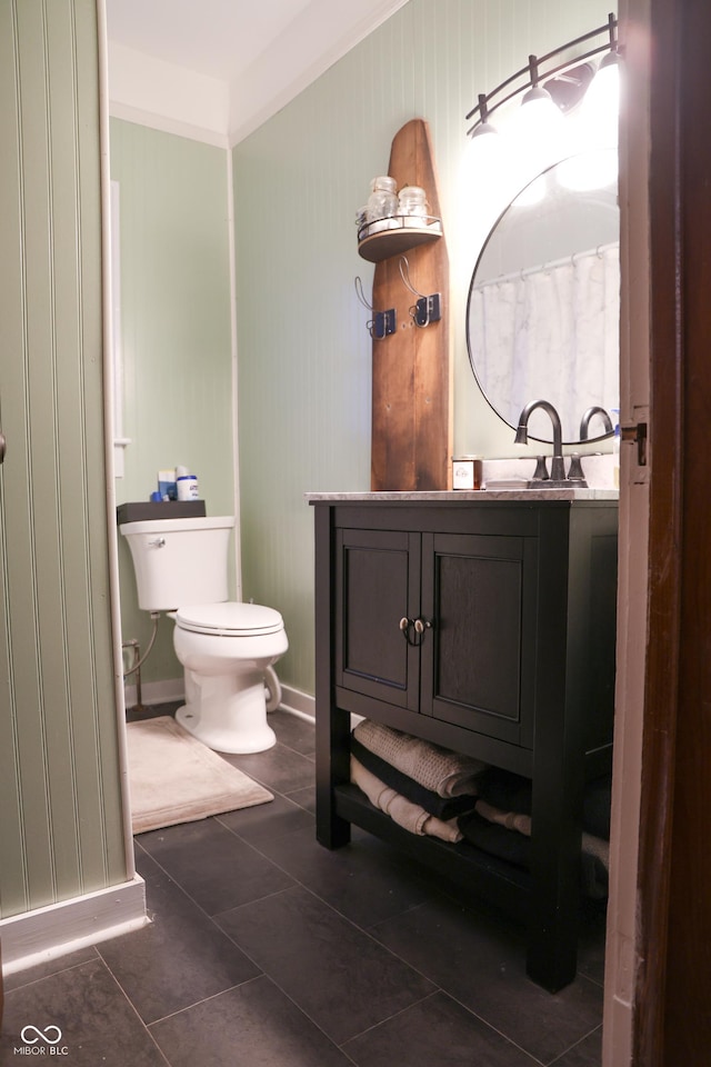 bathroom featuring tile patterned floors, vanity, and toilet