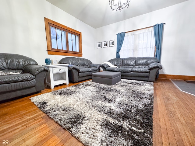 living room featuring a chandelier and hardwood / wood-style flooring