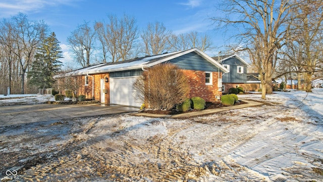 view of snowy exterior with a garage