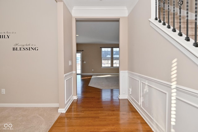 corridor featuring hardwood / wood-style floors and crown molding