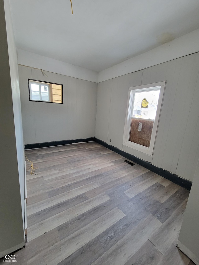 spare room with light wood-type flooring