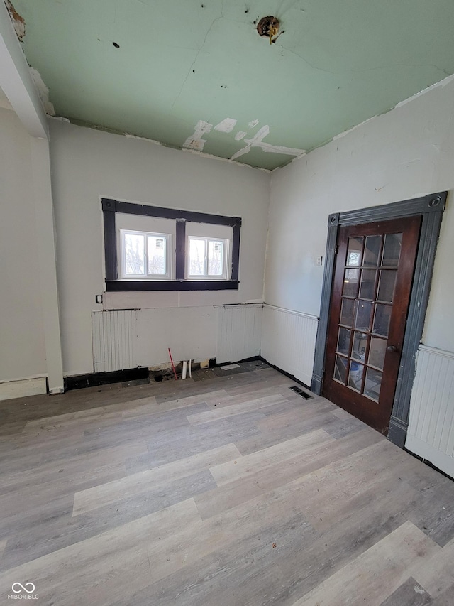 unfurnished room with light hardwood / wood-style floors and radiator