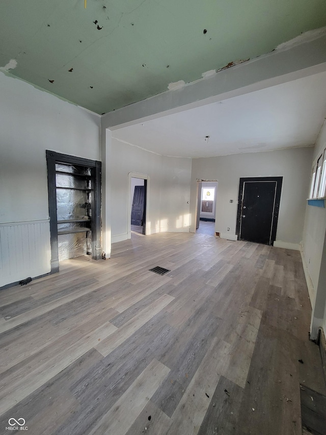 unfurnished living room featuring light wood-type flooring