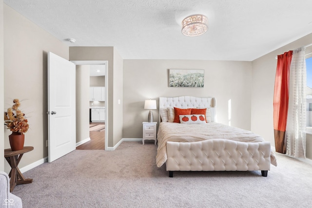 bedroom featuring a textured ceiling and carpet flooring