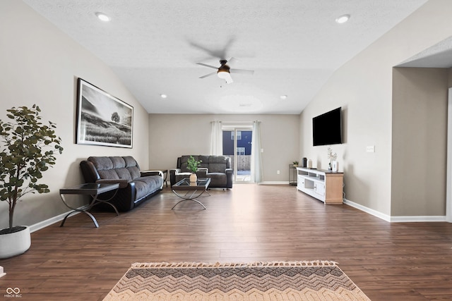 living room with a textured ceiling, dark hardwood / wood-style flooring, and vaulted ceiling