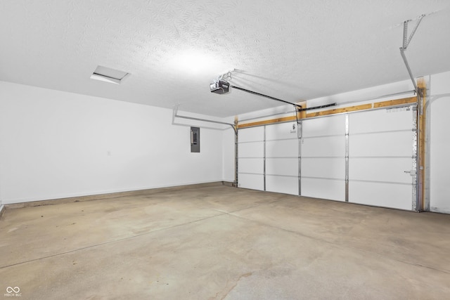 garage with a garage door opener and electric panel