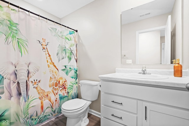 bathroom featuring hardwood / wood-style floors, toilet, and vanity