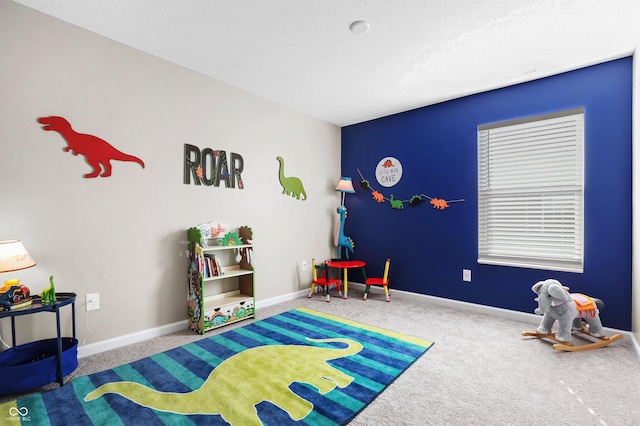 game room featuring carpet and a textured ceiling