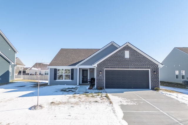 view of front of home featuring a garage and central air condition unit