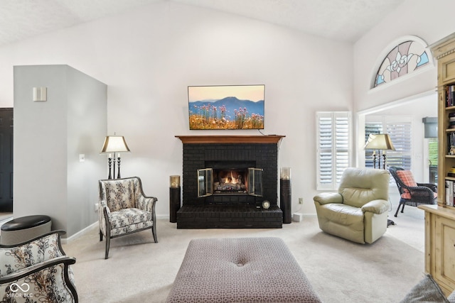 carpeted living room with a fireplace and high vaulted ceiling