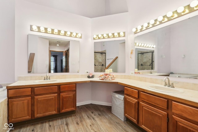 bathroom with vanity, hardwood / wood-style flooring, and a shower