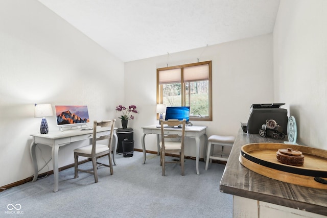 home office featuring vaulted ceiling and carpet